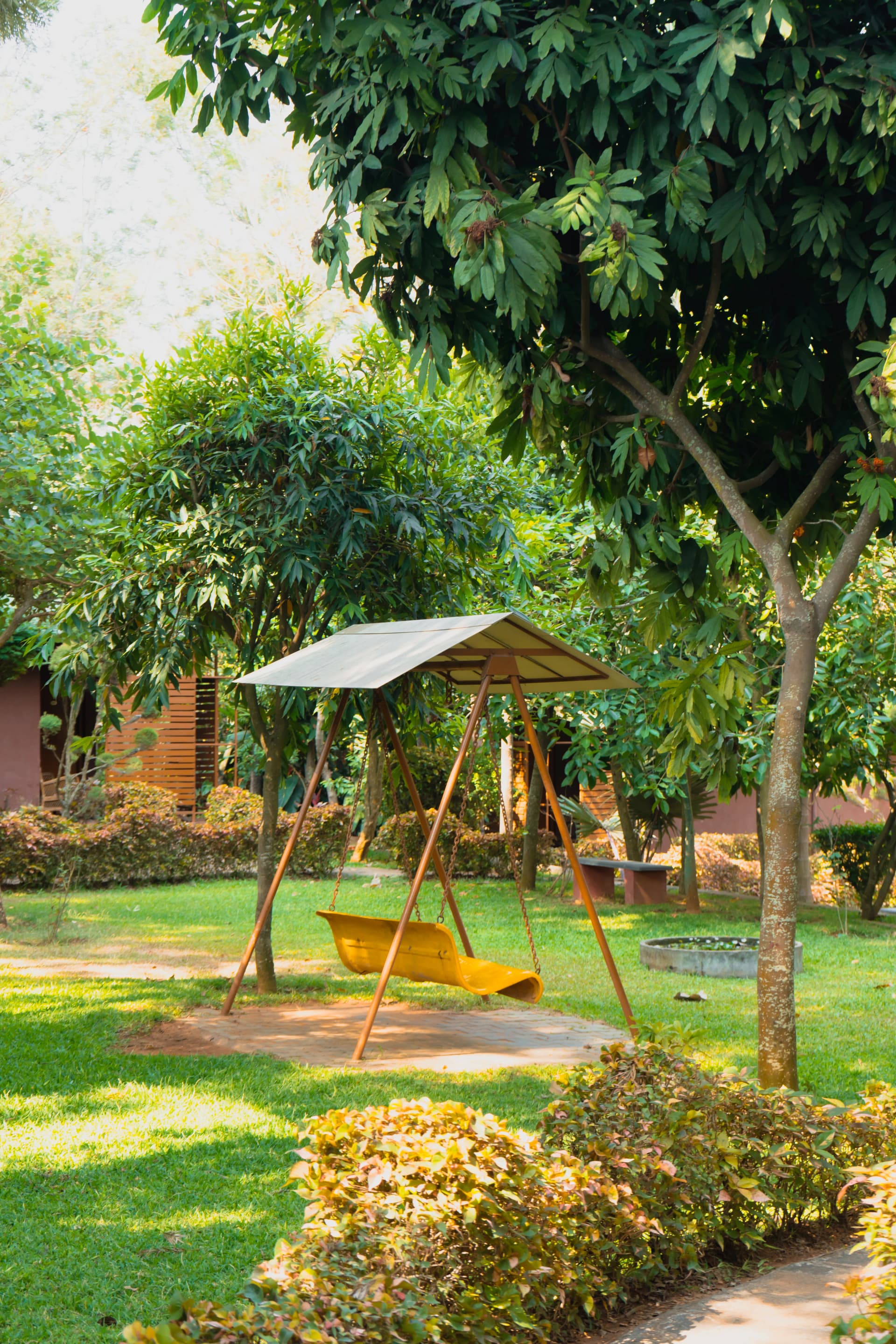 Garden swing under shady trees