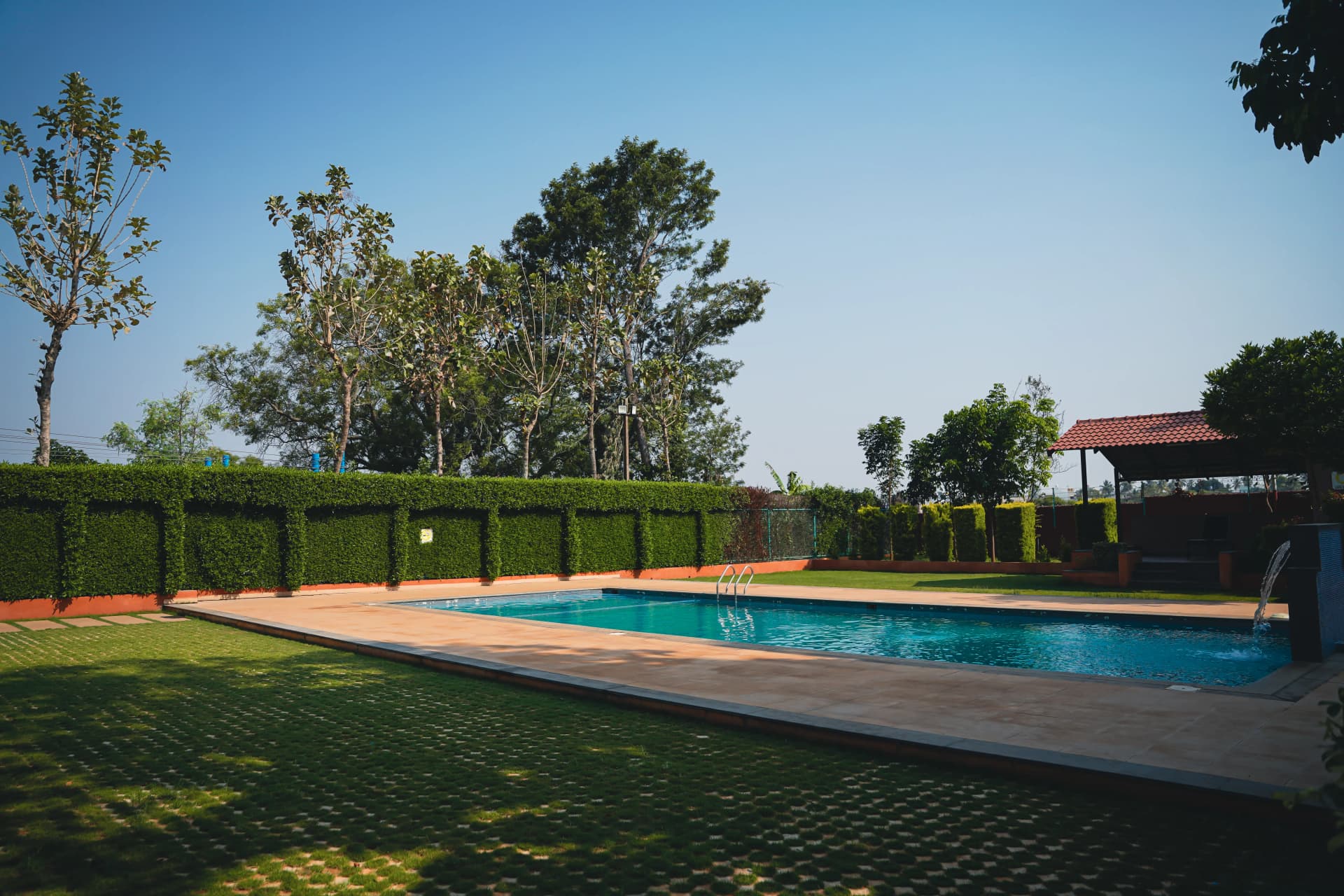 Resort pool with hedge surround at Sharmada