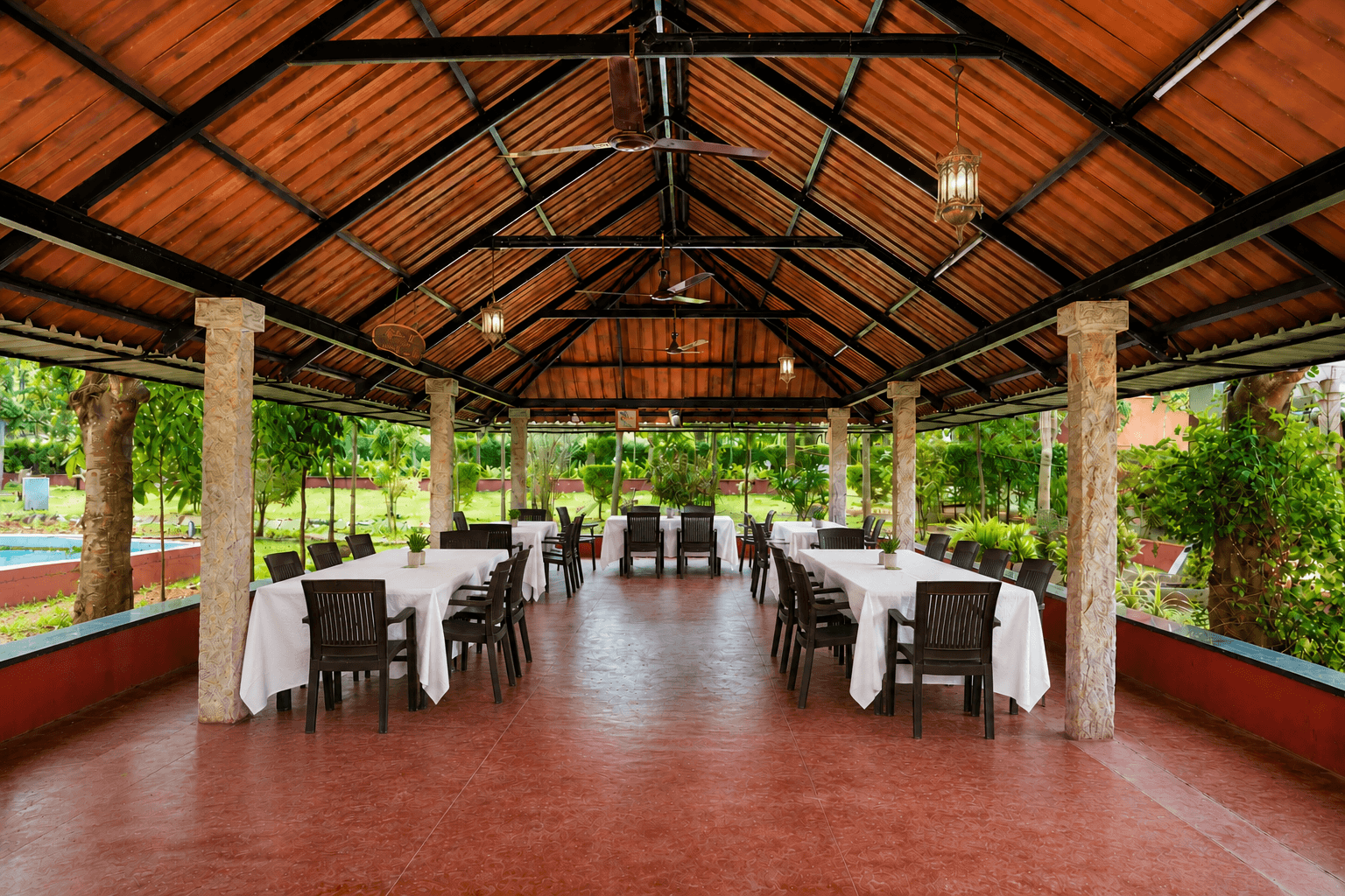 Outdoor dining pavilion with elegant setup at Sharmada Hidden Nest